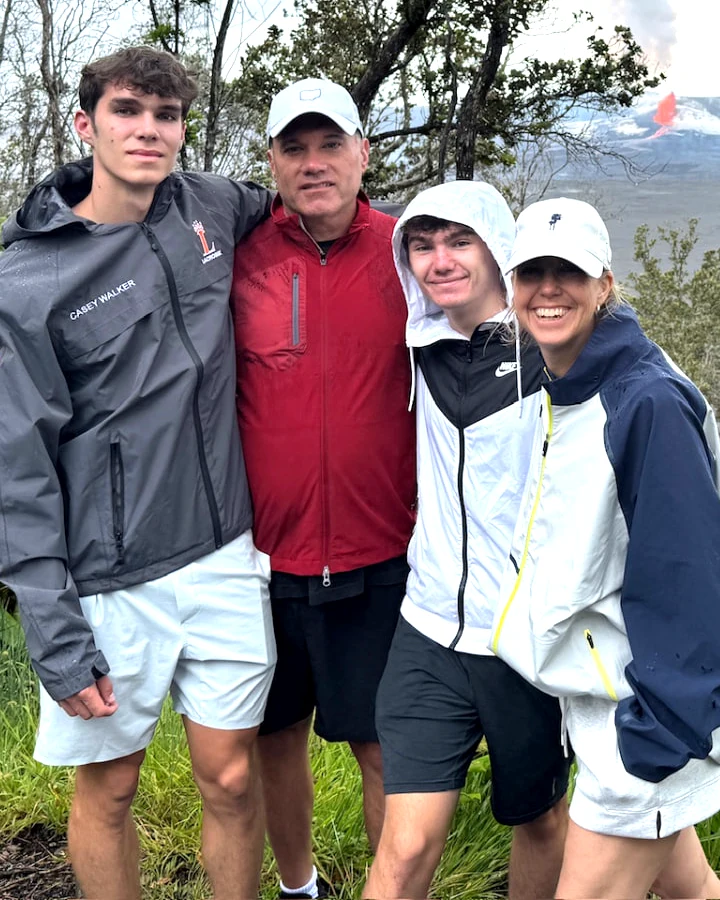 Diane, founder of The Wellness Basket, with her husband and two sons on a hike in Hawaii